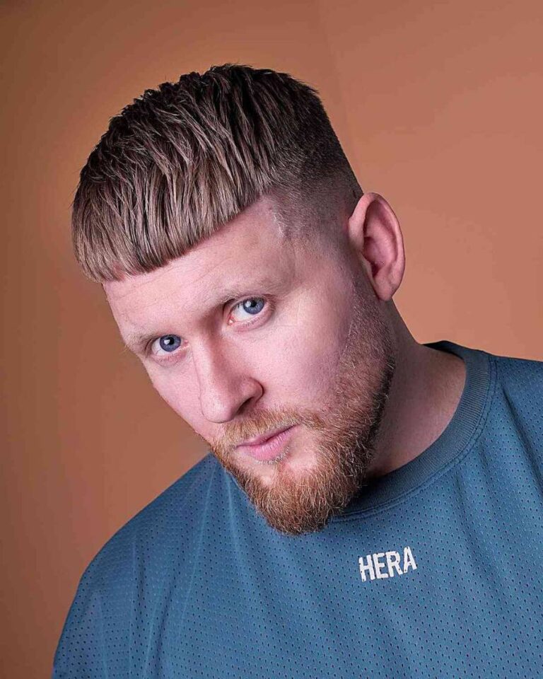 This is a young man with a textured caesar haircut.